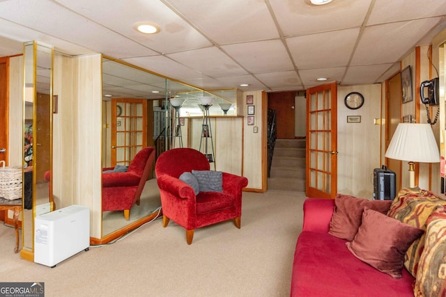 living room featuring french doors, carpet floors, and a paneled ceiling