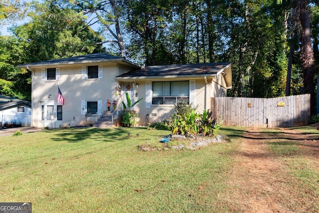 split level home with a front lawn