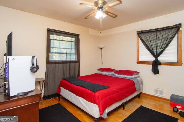 bedroom with hardwood / wood-style flooring and ceiling fan