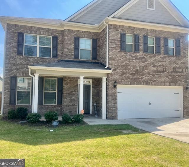 view of front of house with a garage and a front lawn