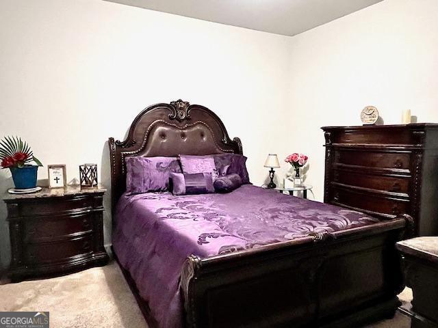 bedroom featuring light colored carpet