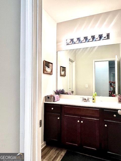 bathroom featuring vanity and wood-type flooring