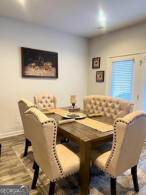 dining area with hardwood / wood-style floors