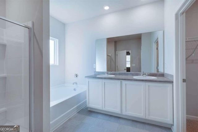 bathroom with vanity and independent shower and bath