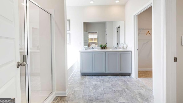 bathroom featuring vanity and an enclosed shower