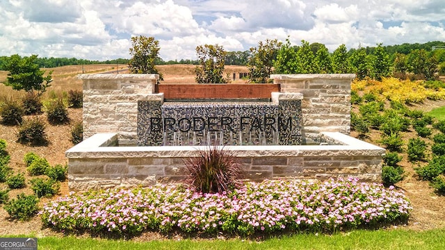 community / neighborhood sign featuring a rural view