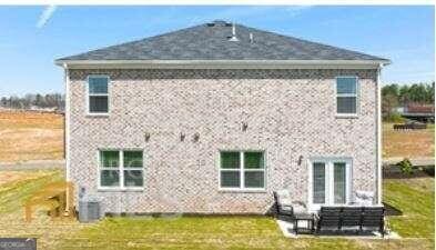 rear view of house featuring a patio area and a yard