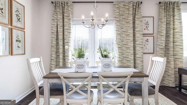 dining room featuring breakfast area, dark hardwood / wood-style floors, and an inviting chandelier