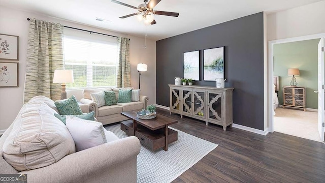 living room with ceiling fan and dark hardwood / wood-style flooring