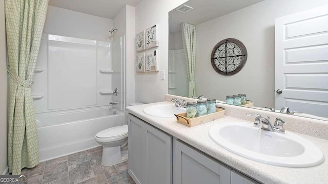 full bathroom featuring vanity, shower / bath combination with curtain, and toilet