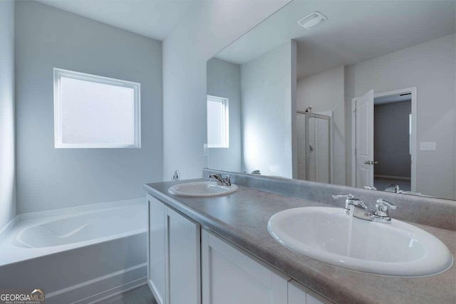 bathroom featuring vanity and separate shower and tub