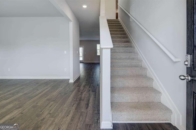 stairs featuring hardwood / wood-style floors