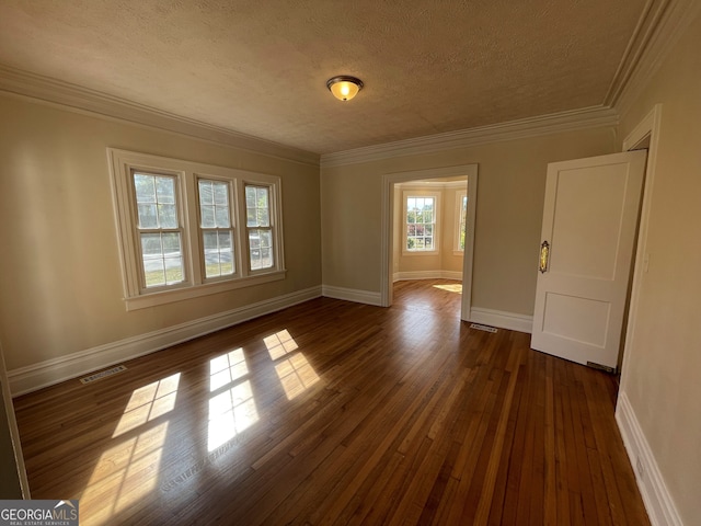empty room with crown molding, a textured ceiling, and dark hardwood / wood-style flooring