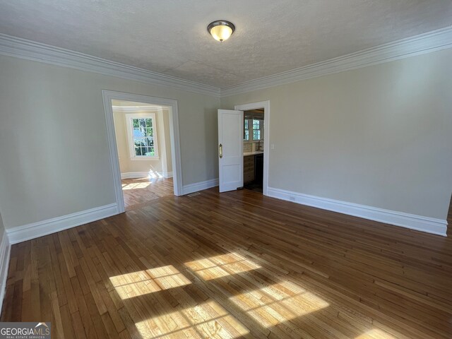 425 E 9th St SE, Rome, GA 30161 - empty room featuring baseboards, dark wood-style flooring, ornamental molding, and a textured ceiling