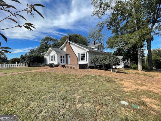 view of side of home with a yard