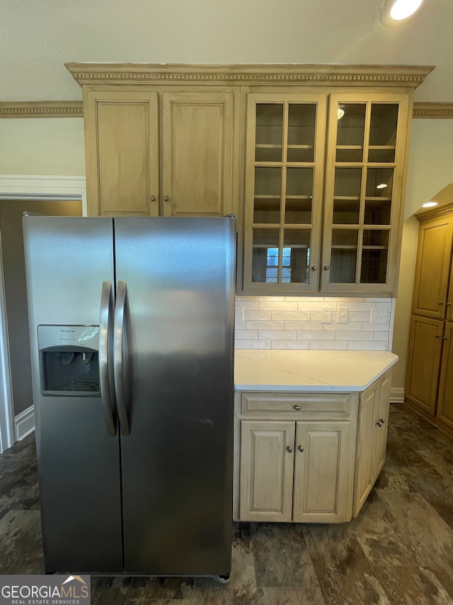 kitchen with stainless steel fridge and tasteful backsplash