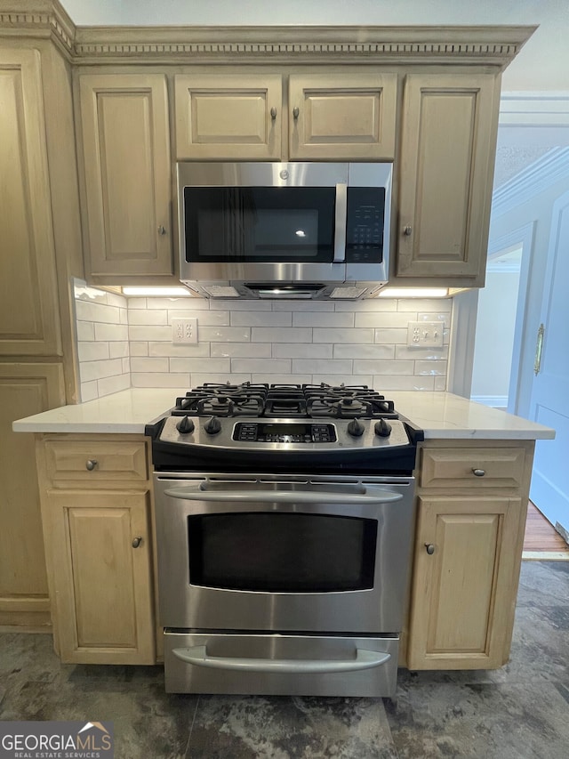 kitchen with decorative backsplash and appliances with stainless steel finishes