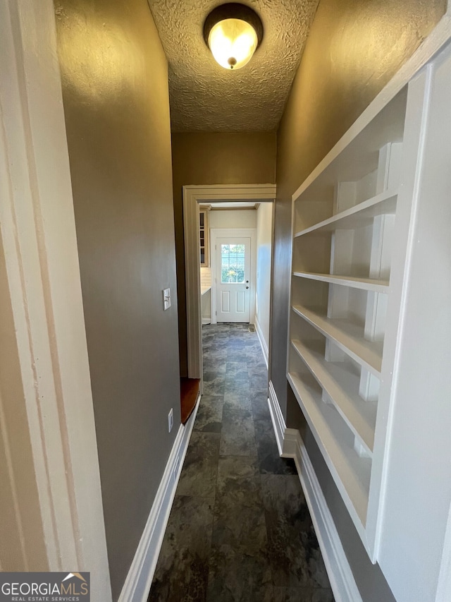 hallway featuring a textured ceiling