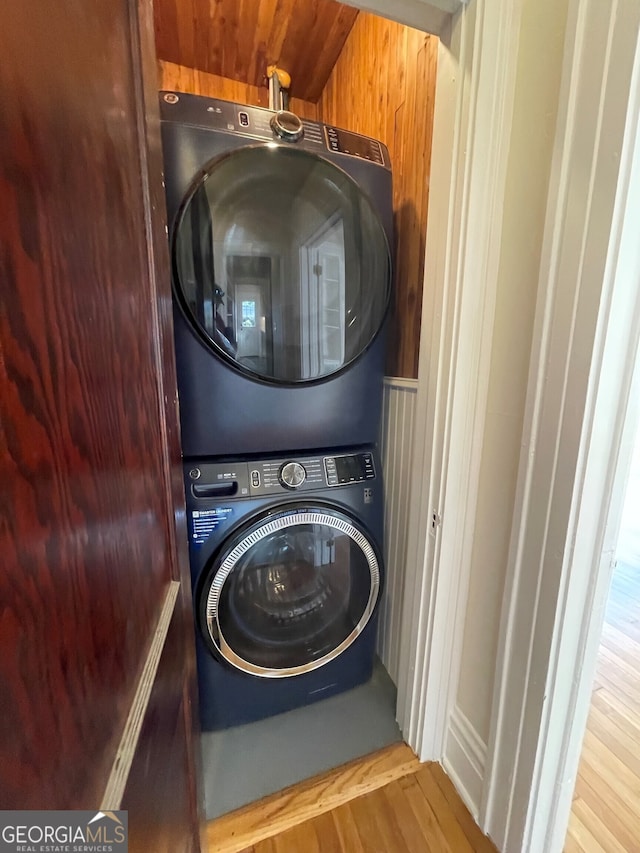 washroom featuring light hardwood / wood-style floors and stacked washer / drying machine