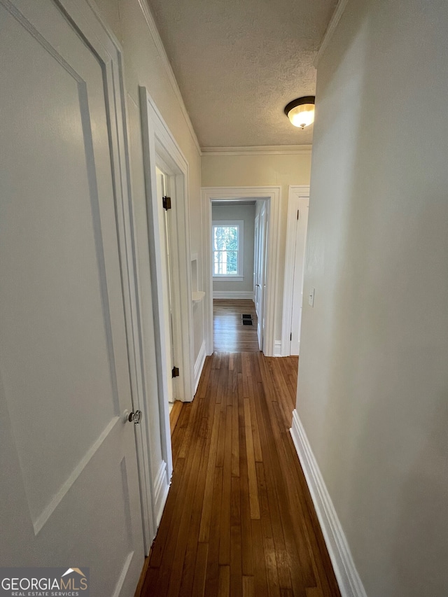 425 E 9th St SE, Rome, GA 30161 - hallway with ornamental molding, dark wood-style floors, baseboards, and a textured ceiling