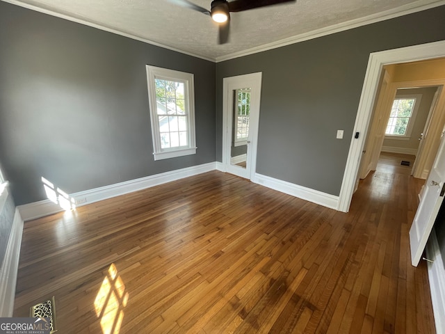 spare room with ceiling fan, dark hardwood / wood-style floors, and plenty of natural light