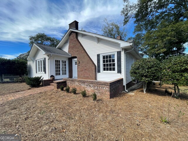 425 E 9th St SE, Rome, GA 30161 - view of front of house with a chimney, french doors, and brick siding