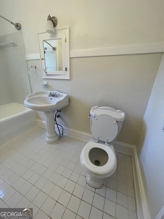 bathroom with toilet, tub / shower combination, and tile patterned flooring
