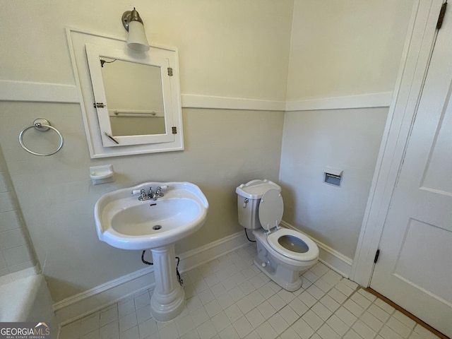 bathroom with toilet and tile patterned flooring