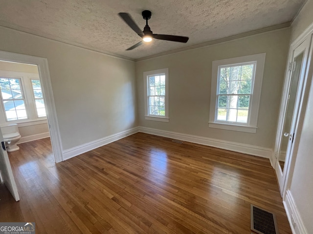 empty room featuring crown molding, a textured ceiling, hardwood / wood-style flooring, and ceiling fan
