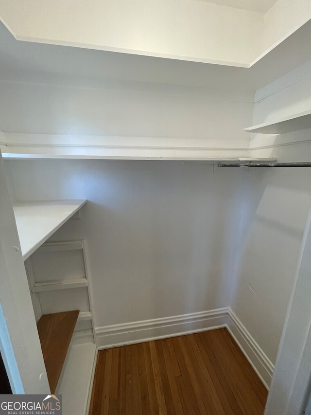 walk in closet featuring hardwood / wood-style flooring