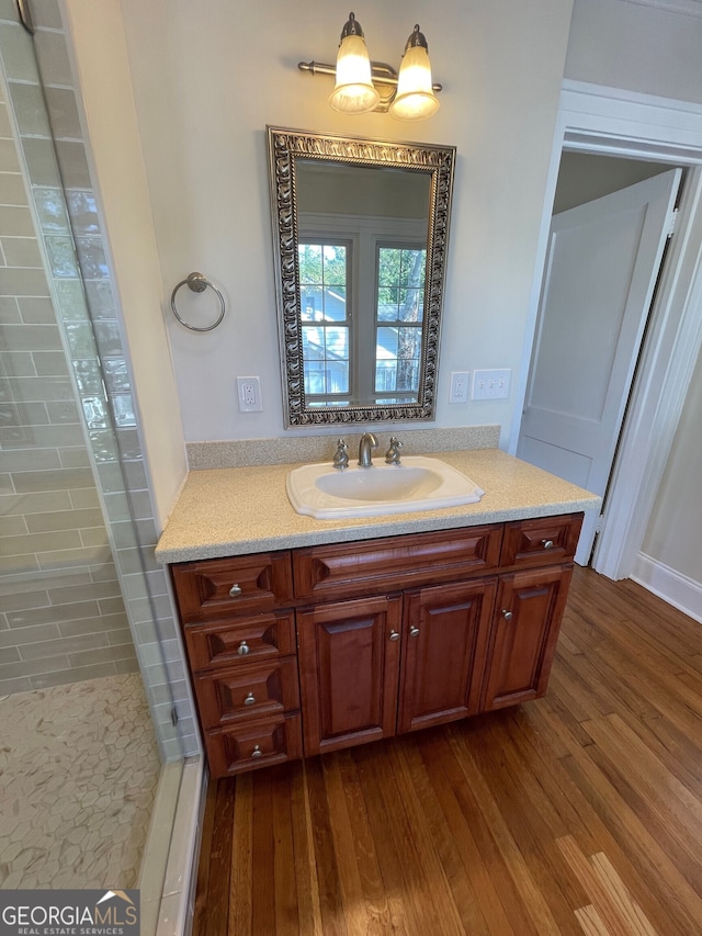 bathroom featuring vanity, hardwood / wood-style flooring, and walk in shower