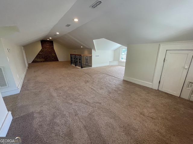 bonus room with carpet floors and vaulted ceiling