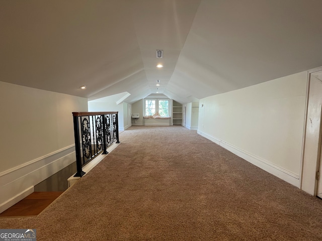 bonus room featuring lofted ceiling and carpet flooring