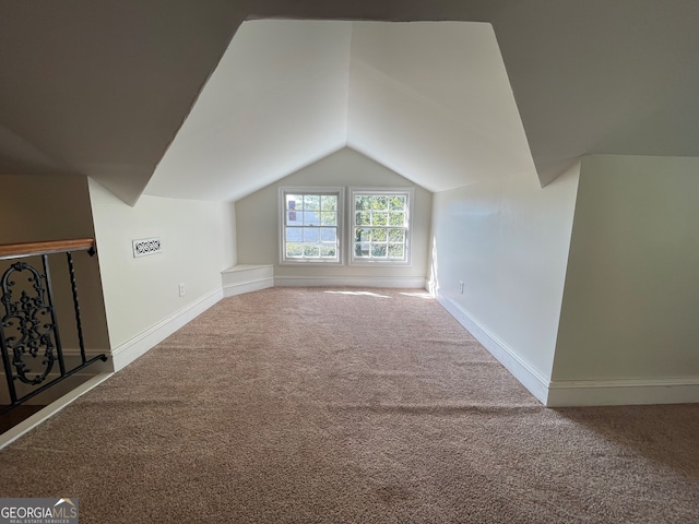 bonus room with lofted ceiling and carpet floors
