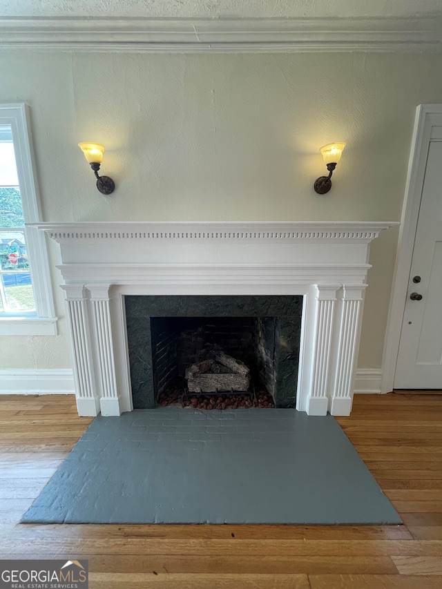 interior details featuring ornamental molding and hardwood / wood-style floors