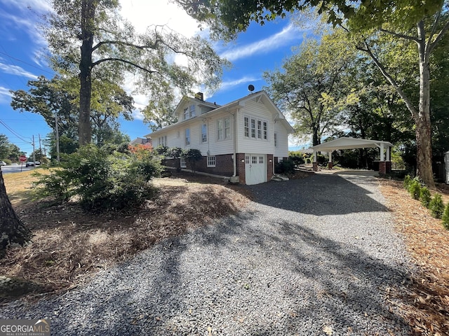 view of side of home with a carport