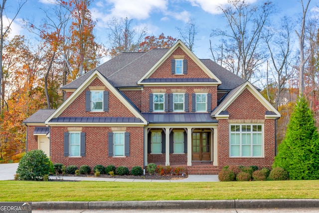 craftsman house with french doors and a front lawn