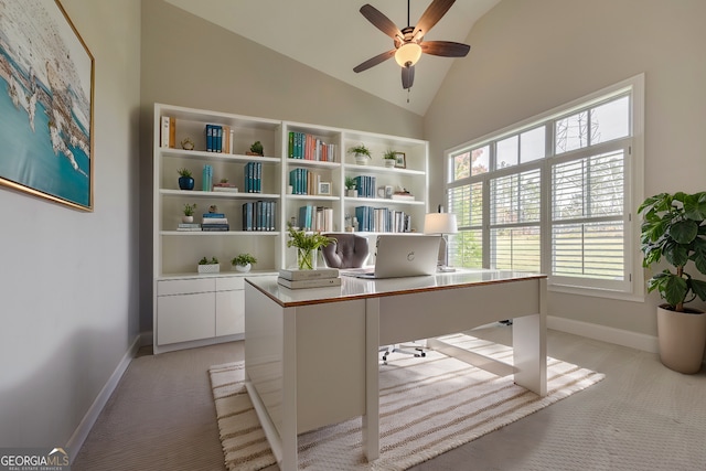 unfurnished office with ceiling fan, light carpet, and high vaulted ceiling