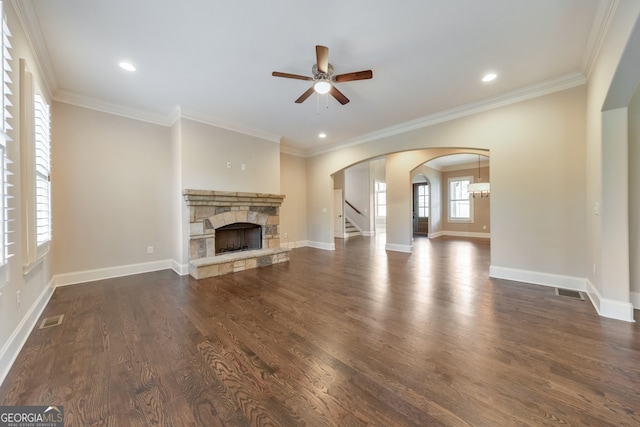 unfurnished living room with a fireplace, ceiling fan, dark hardwood / wood-style flooring, and crown molding