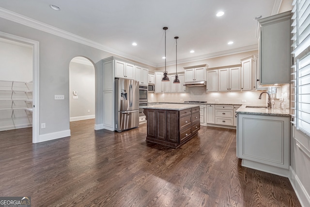 kitchen with a center island, hanging light fixtures, light stone counters, dark hardwood / wood-style flooring, and stainless steel appliances