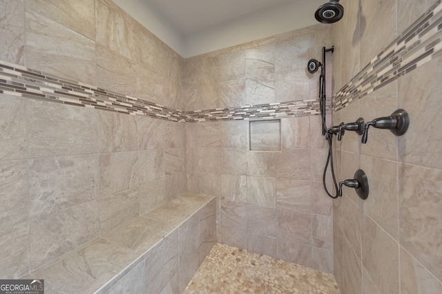 bathroom with tiled shower