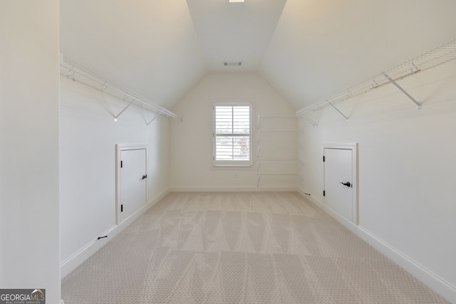 clothes washing area featuring light carpet