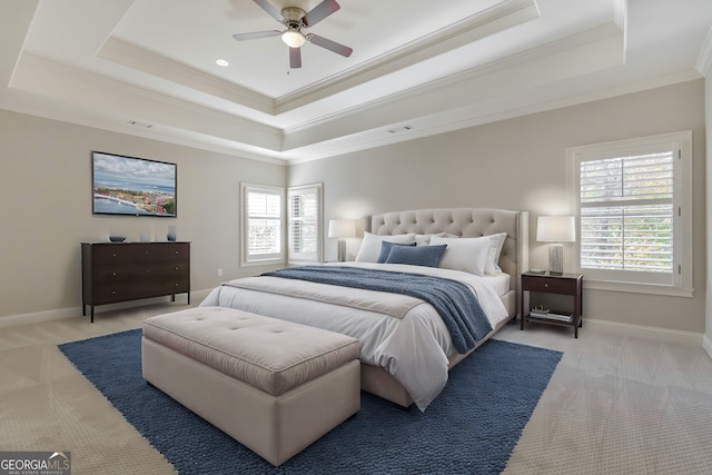 carpeted bedroom with a raised ceiling, ceiling fan, and crown molding