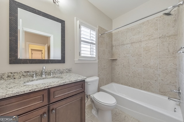 full bathroom with tile patterned floors, tiled shower / bath combo, toilet, and vanity