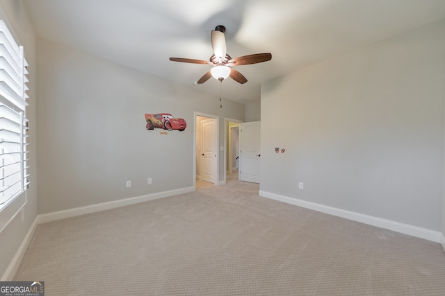 unfurnished bedroom with ceiling fan and light colored carpet