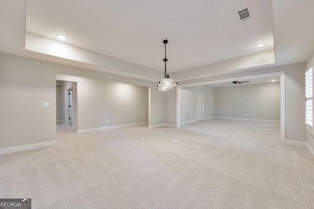 basement with light colored carpet and ceiling fan