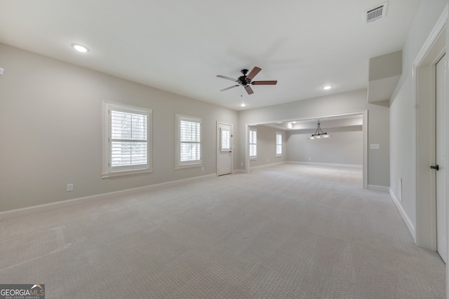 unfurnished living room with light carpet and ceiling fan