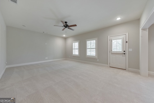 interior space with light colored carpet and ceiling fan