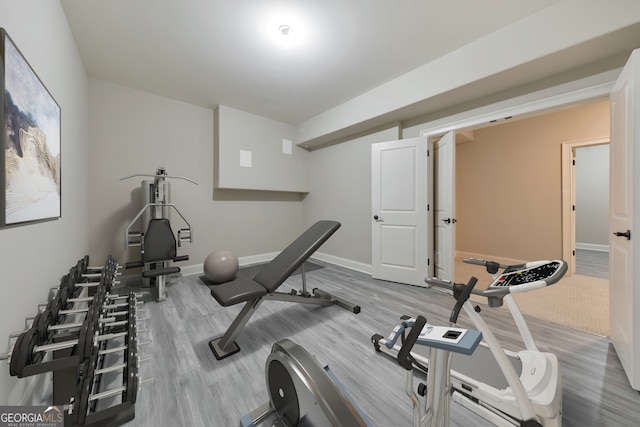 exercise room with hardwood / wood-style floors