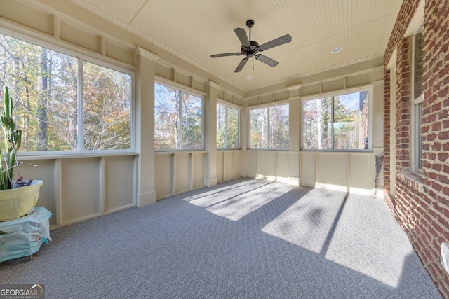 sunroom featuring ceiling fan and a healthy amount of sunlight